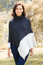 Model Perrie wearing The Panel Knit Poncho in colour Charcoal (Black), from the front, showing the whole outfit