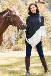 Model Perrie wearing The Panel Knit Poncho in colour Charcoal (Black), from the front, showing the whole outfit