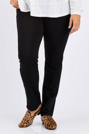 Model Mae wearing size 16 of The Slim Leg Powerstretch Jean in colour Black (Black), from the front, cropped image