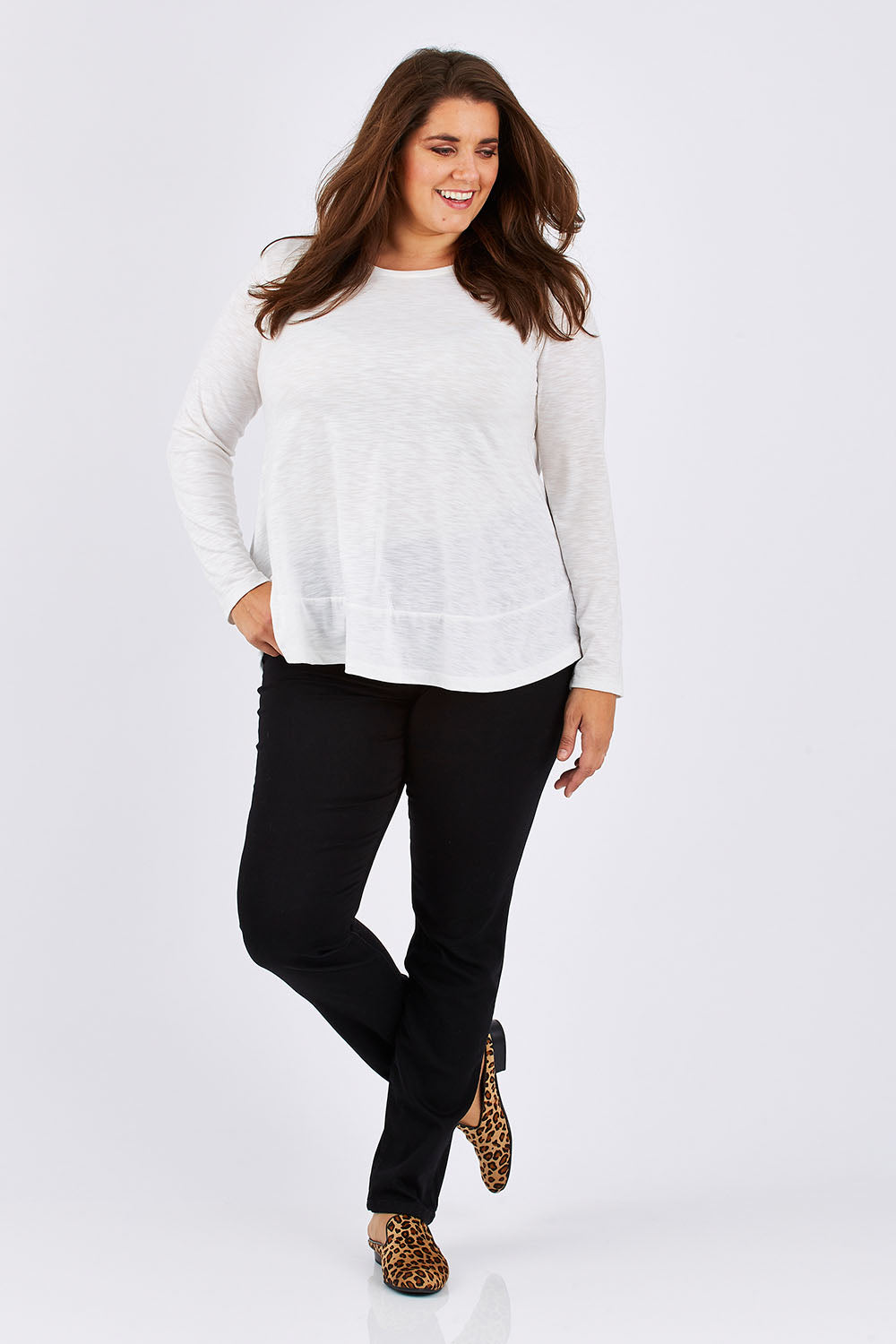 Model Mae wearing size 18 of The Slim Leg Powerstretch Jean in colour Black (Black), from the front, showing the whole outfit