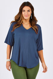 Model Laura wearing size 12 of The Stella Tee in colour Blue (Blue), from the front, cropped image