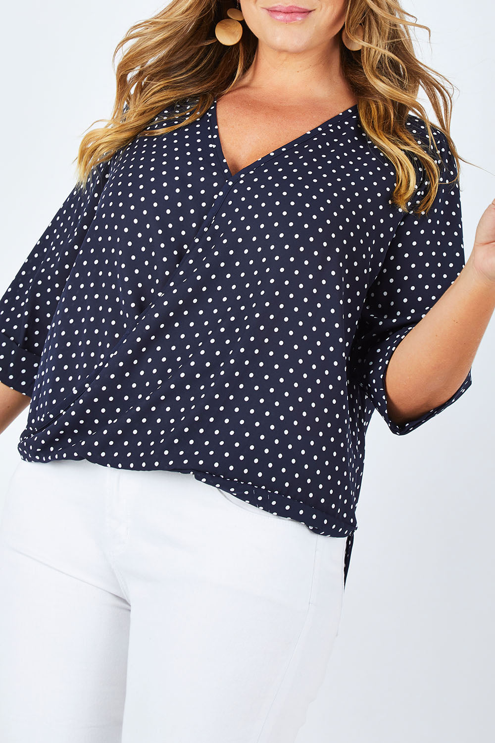 Model Fiona wearing size 16 of The Cross Front Spot Blouse in colour NavySpot (Blue), from the front, cropped image