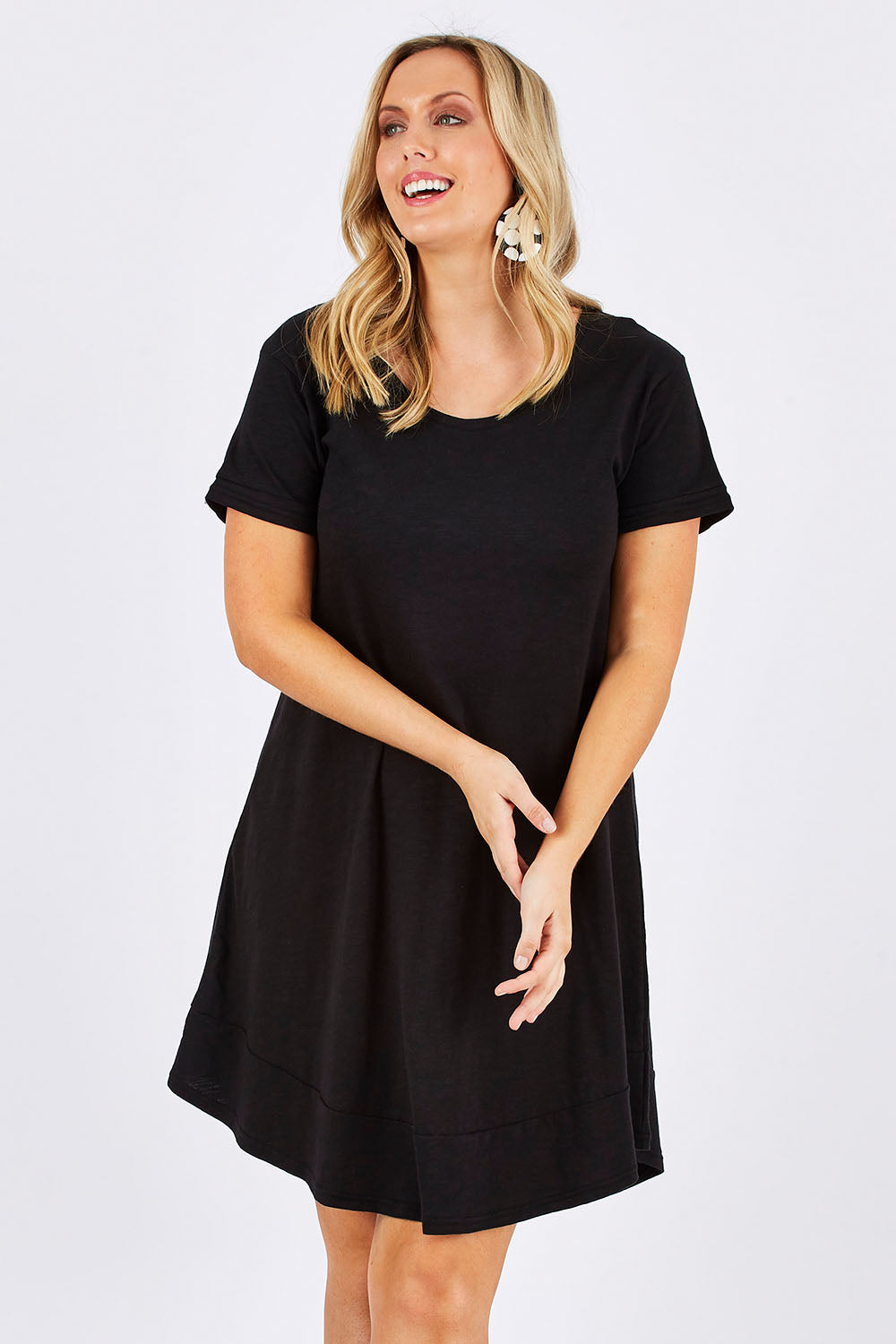 Model Jess wearing size 12 of The Swing Dress in colour Black (Black), from the front, cropped image