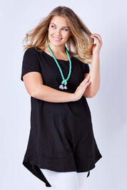 Model Kate wearing size 16 of The Swing Dress in colour Black (Black), from the front, cropped image