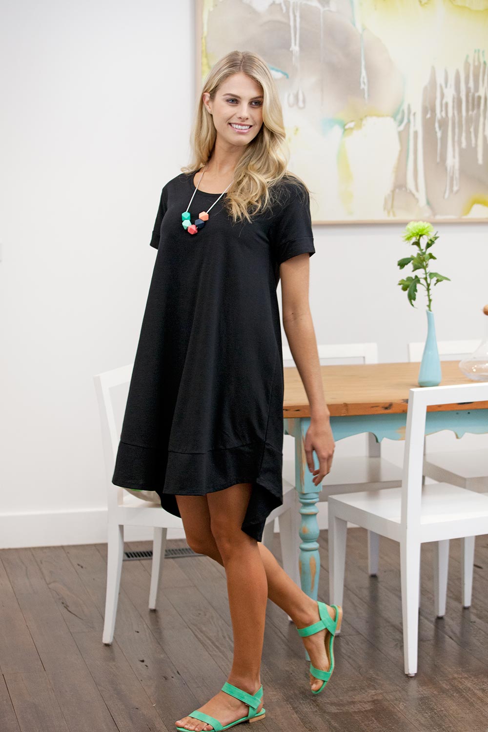 Model Natalie wearing size 8 of The Swing Dress in colour Black (Black), from the front, showing the whole outfit