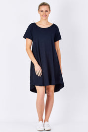 Model Maddy wearing size 10 of The Swing Dress in colour Navy (Blue), from the front, showing the whole outfit