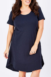 Model Mae wearing size 16 of The Swing Dress in colour Navy (Blue), from the front, cropped image
