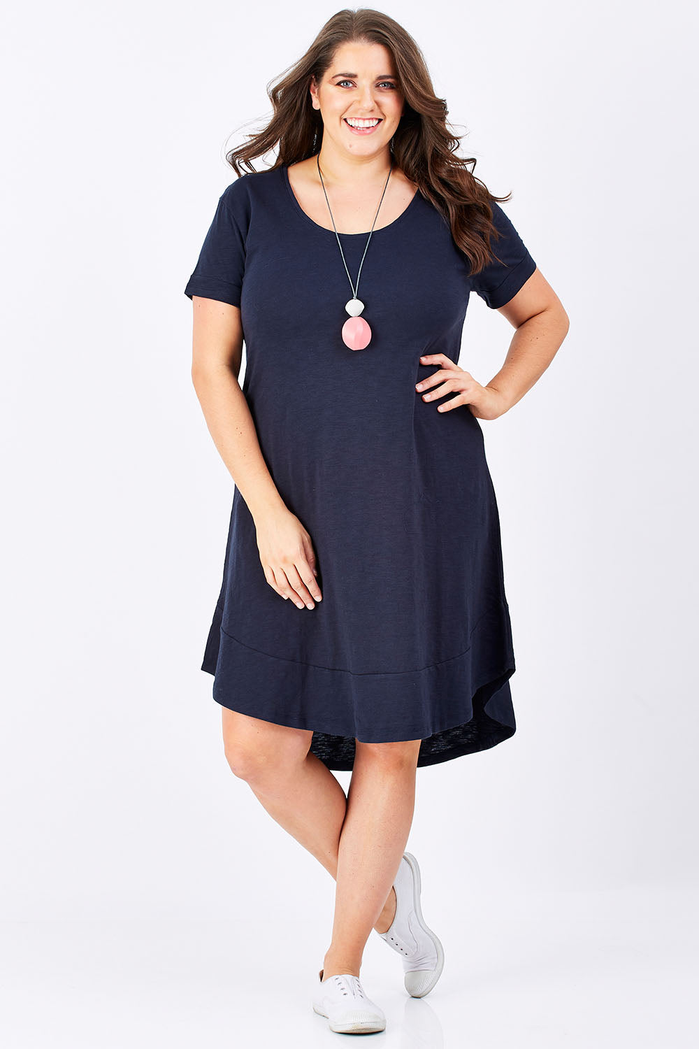 Model Mae wearing size 16 of The Swing Dress in colour Navy (Blue), from the front, showing the whole outfit