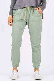 Model Emma wearing size 10 of The Weekender Pant in colour Khaki (Green), from the front, cropped image
