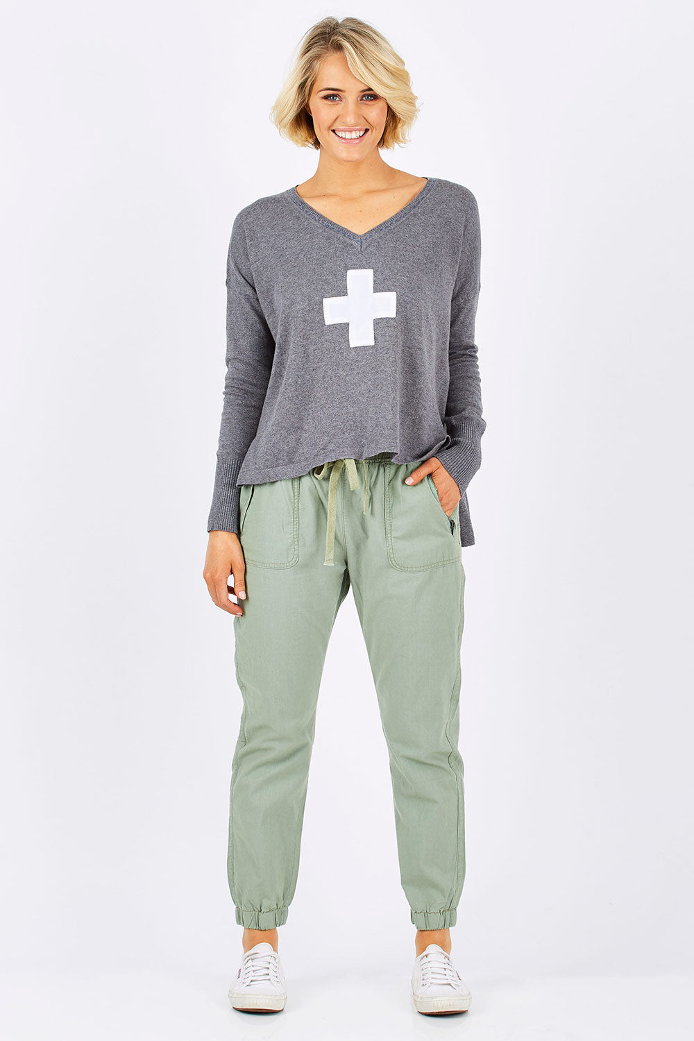 Model Emma wearing size 10 of The Weekender Pant in colour Khaki (Green), from the front, showing the whole outfit