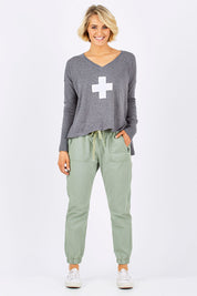 Model Emma wearing size 10 of The Weekender Pant in colour Khaki (Green), from the front, showing the whole outfit