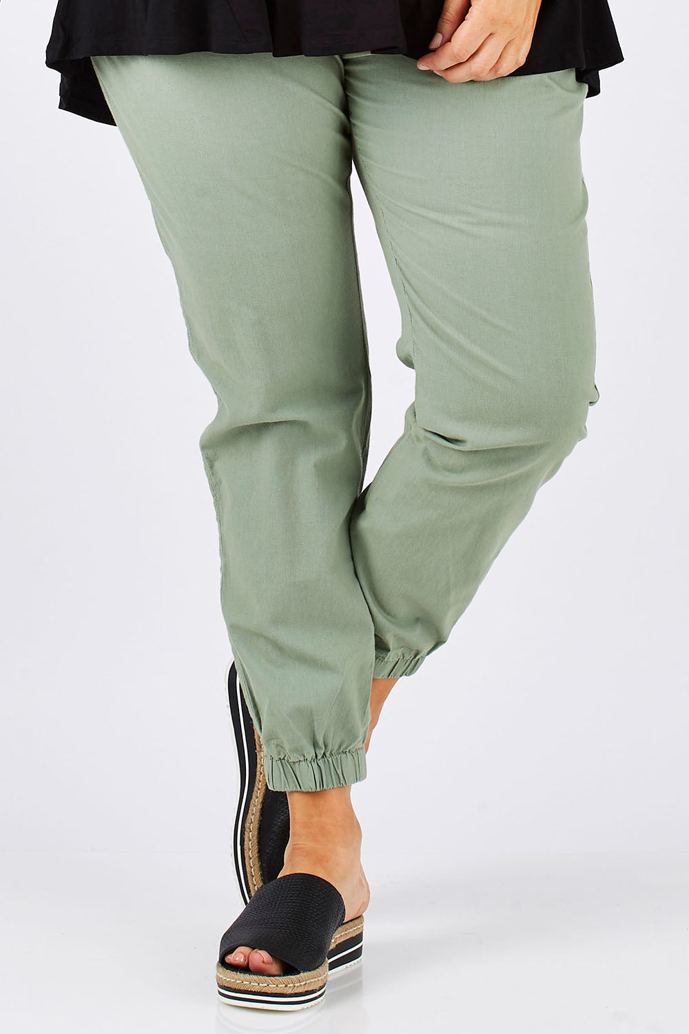 Model Ljubenka wearing size 18 of The Weekender Pant in colour Khaki (Green), from the front, cropped image