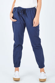 Model Chelsea wearing size 10 of The Weekender Pant in colour Navy (Blue), from the front, cropped image