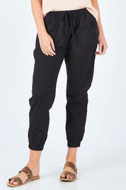 Model Chelsea wearing size 10 of The Weekender Pant in colour WashedBlac (Black), from the front, cropped image