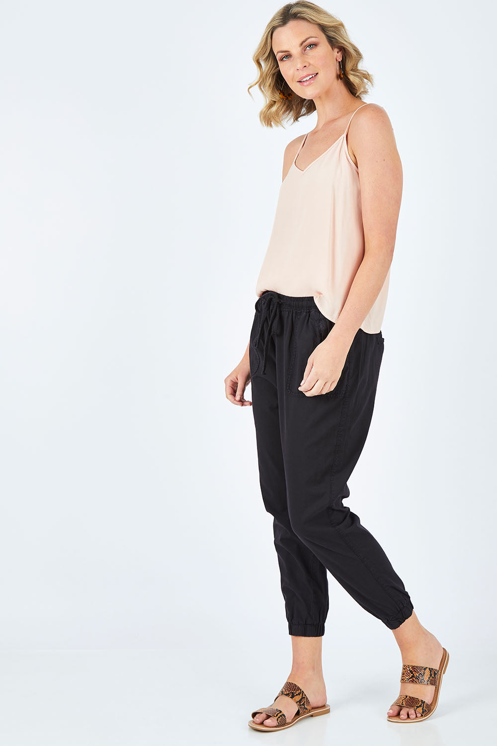 Model Chelsea wearing size 10 of The Weekender Pant in colour WashedBlac (Black), from the front, showing the whole outfit