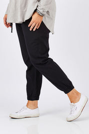 Model Ljubenka wearing size 18 of The Weekender Pant in colour WashedBlac (Black), from the front, cropped image