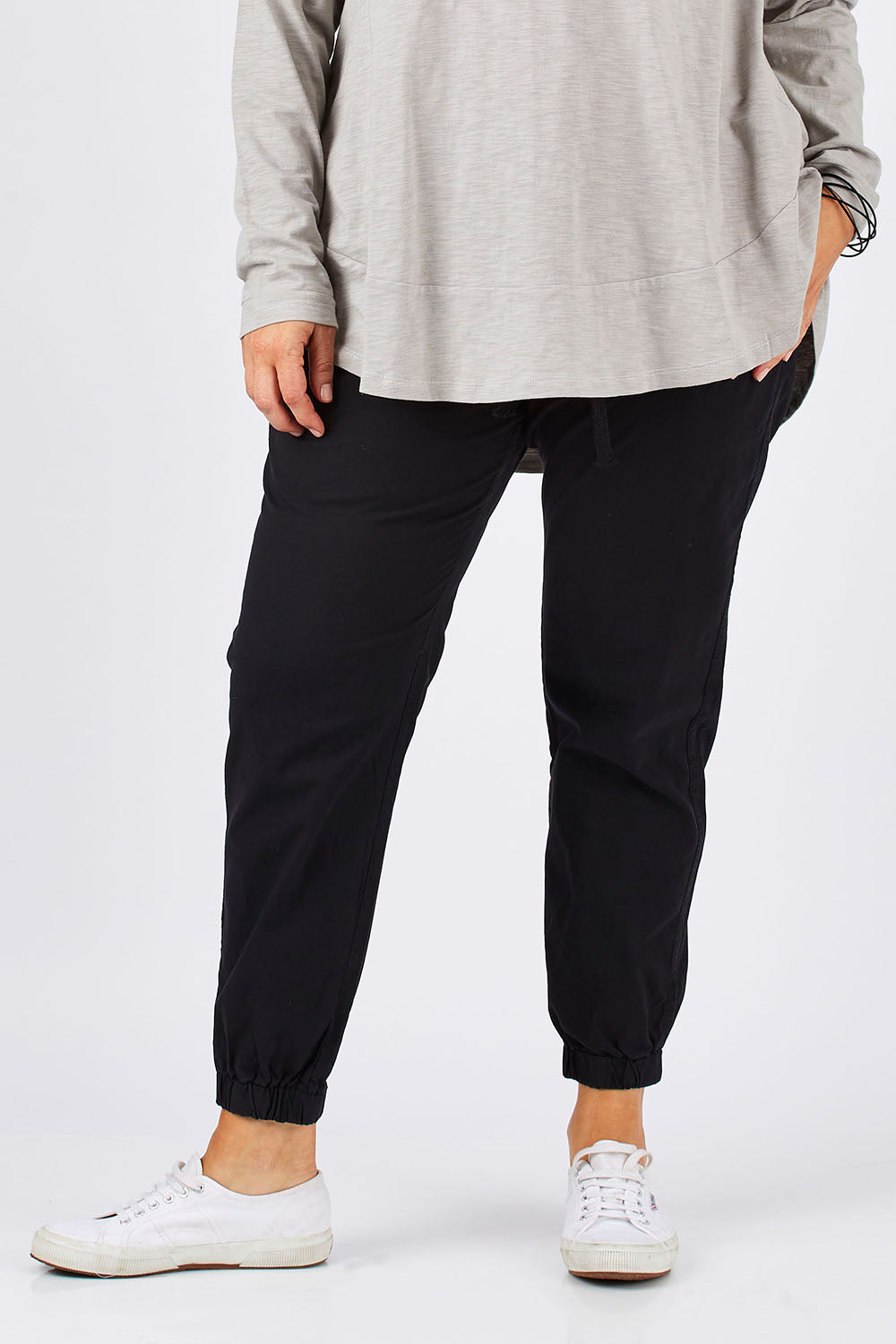 Model Ljubenka wearing size 18 of The Weekender Pant in colour WashedBlac (Black), from the front, cropped image