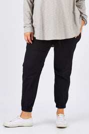 Model Ljubenka wearing size 18 of The Weekender Pant in colour WashedBlac (Black), from the front, cropped image