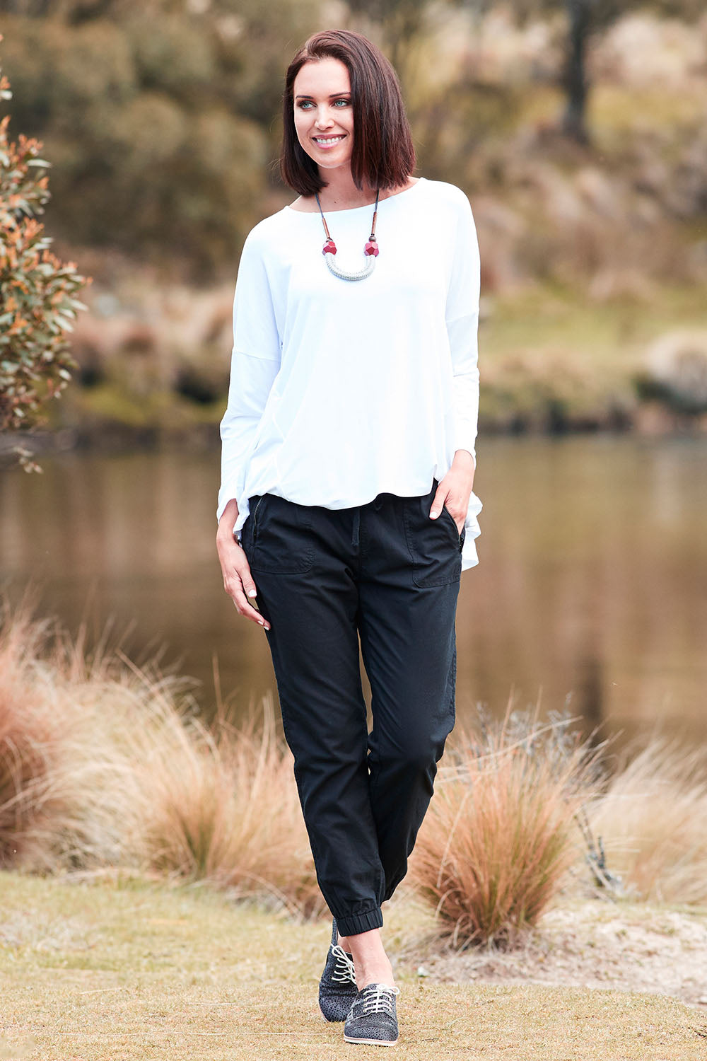 Model Perrie wearing size 10 of The Weekender Pant in colour WashedBlac (Black), from the front, showing the whole outfit