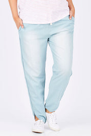 Model Jess wearing size 14 of The Chambray Curved Hem Pant in colour Chambray (Blue), from the front, cropped image