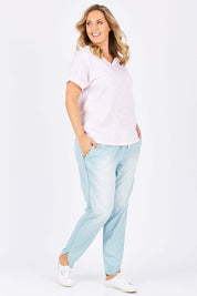Model Jess wearing size 14 of The Chambray Curved Hem Pant in colour Chambray (Blue), from the front, showing the whole outfit