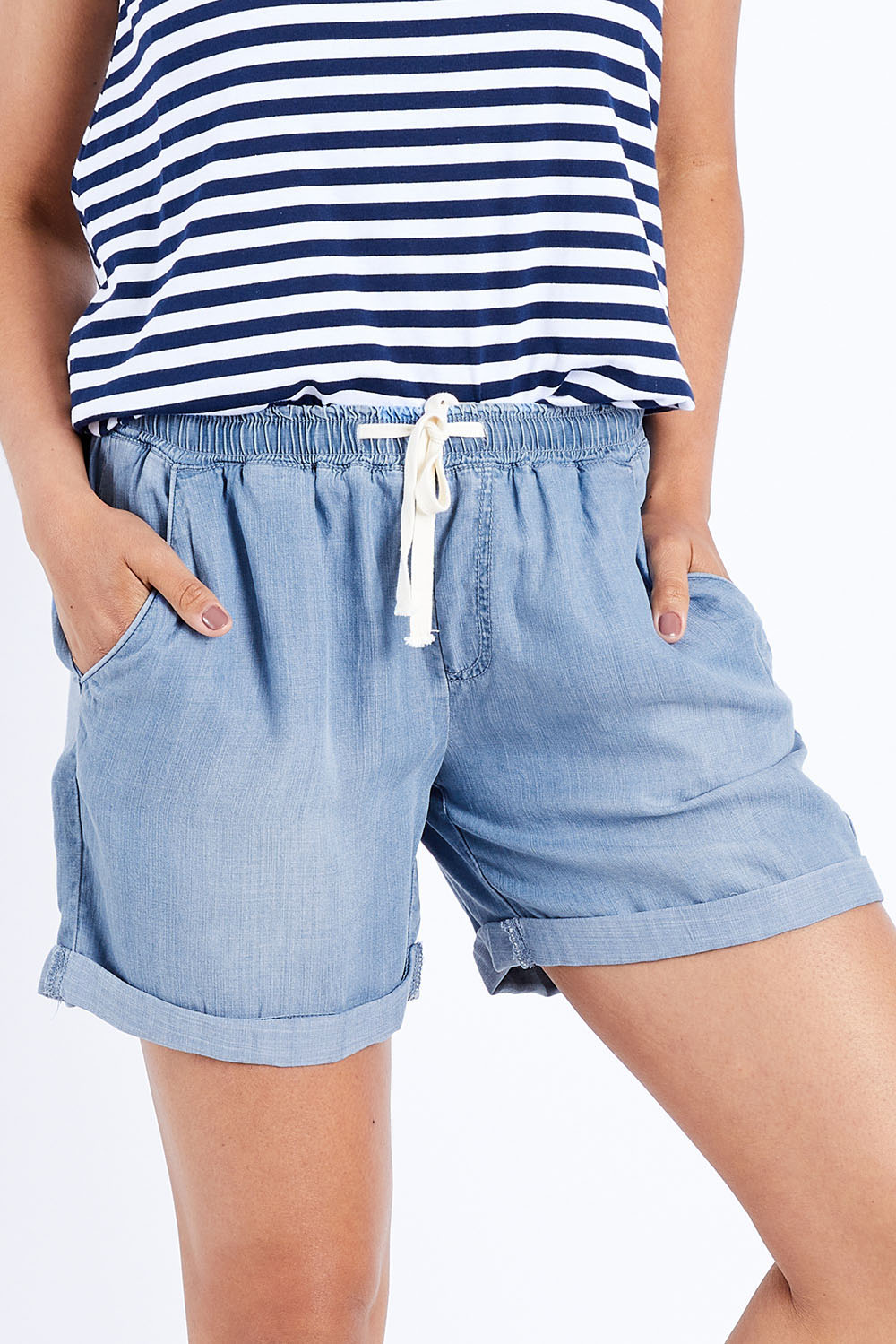 Model Pamela wearing size 10 of The Weekender Chambray Short in colour Blue (Blue), from the front, cropped image