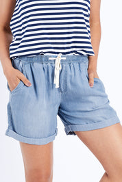 Model Pamela wearing size 10 of The Weekender Chambray Short in colour Blue (Blue), from the front, cropped image