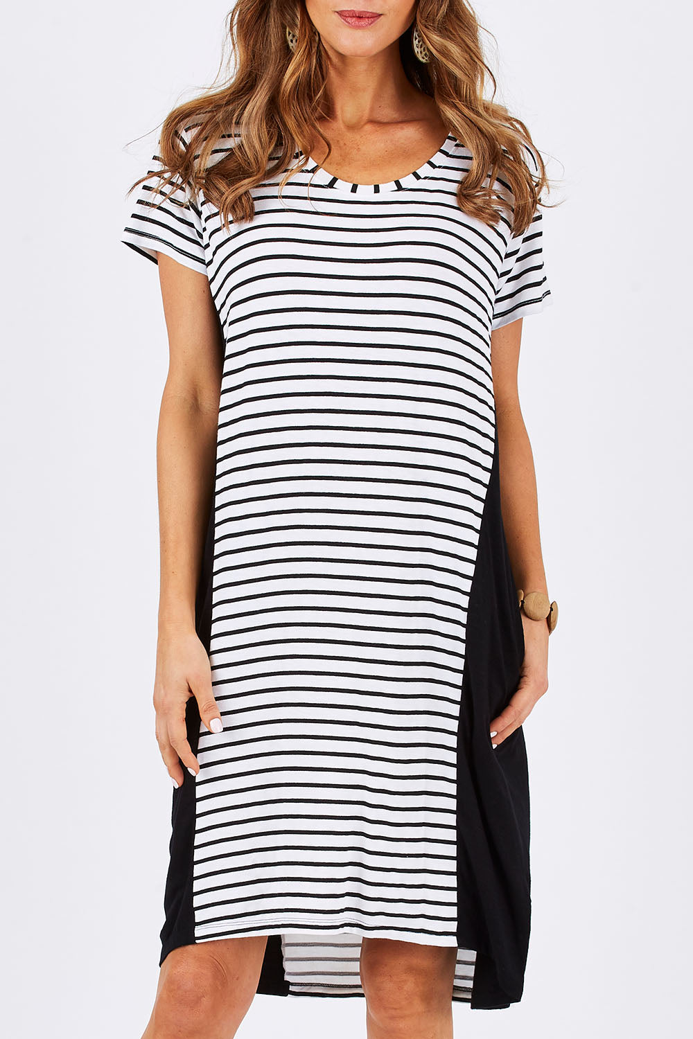 Model Clementine wearing size 10 of The Contrast Panel Dress in colour Blkstripe (Black), from the front, cropped image