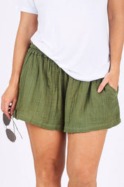 Model Laura wearing size 12 of The Bonded Cotton Short in colour Khaki (Green), from the front, cropped image