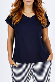 Model Laura wearing size 12 of The Essential Layering Tee in colour Navy (Blue), from the front, cropped image