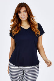 Model Laura wearing size 12 of The Essential Layering Tee in colour Navy (Blue), from the front, cropped image