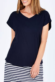Model Riina wearing size 10 of The Essential Layering Tee in colour Navy (Blue), from the front, cropped image