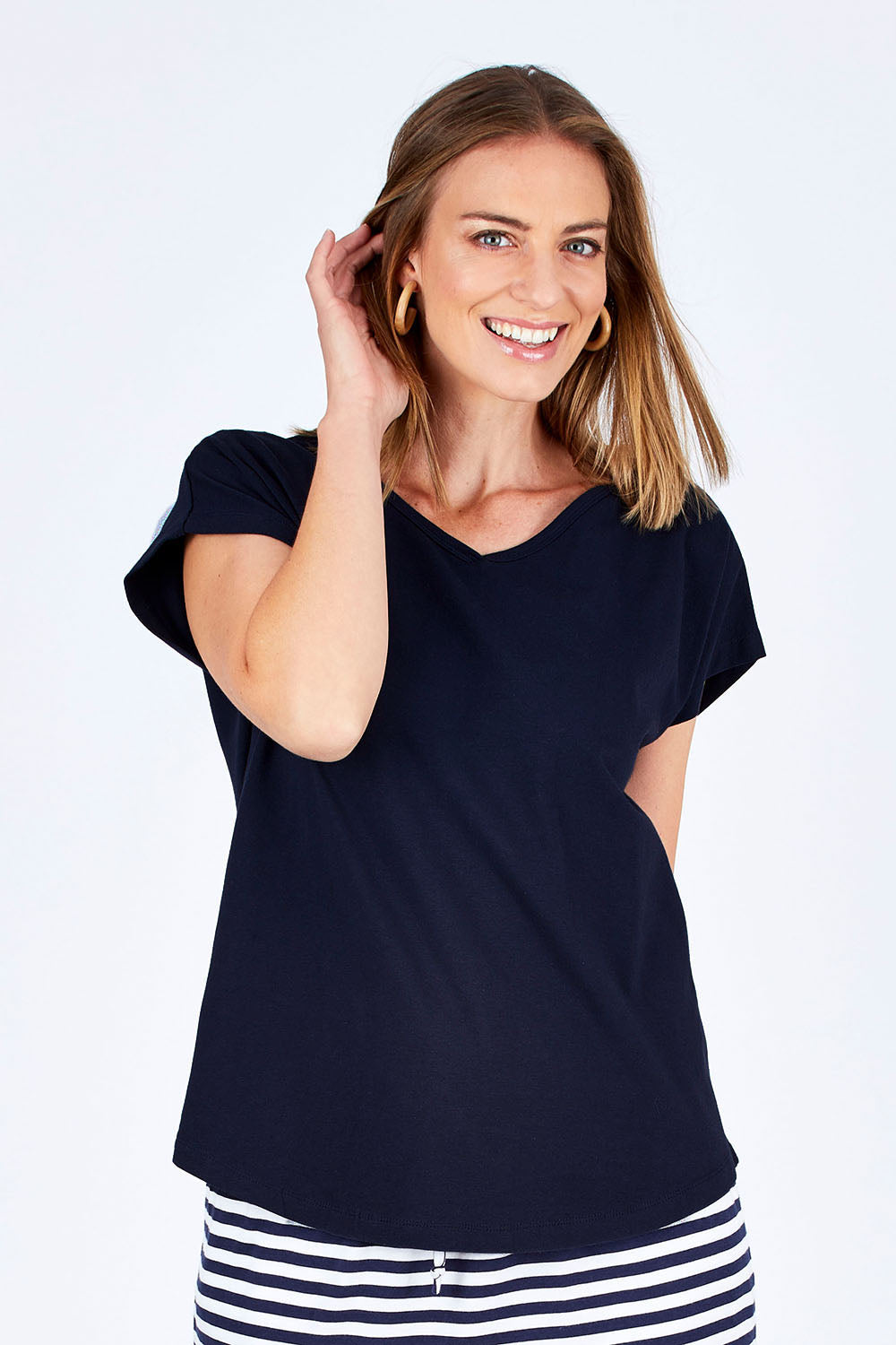 Model Riina wearing size 10 of The Essential Layering Tee in colour Navy (Blue), from the front, cropped image