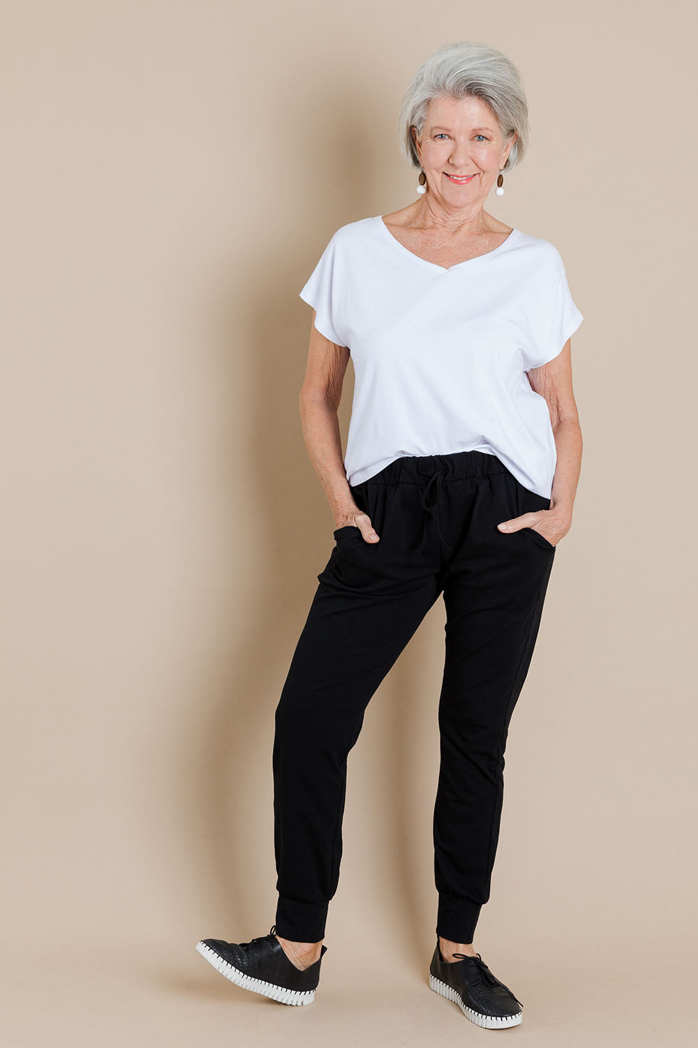 Model Elise wearing size 10 of The Essential Layering Tee in colour White (White), from the front, showing the whole outfit