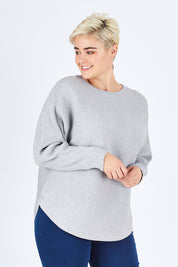 Model Stefania wearing size L of The Daily Essential Jumper in colour Grey (Grey), from the front, cropped image