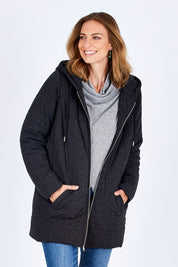Model Riina wearing size 10 of The Luxe Puffer Jacket in colour Charcoal (Black), from the front, cropped image