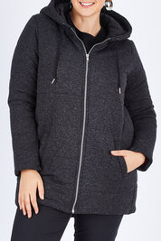 Model Stefania wearing size 14 of The Luxe Puffer Jacket in colour Charcoal (Black), from the front, cropped image