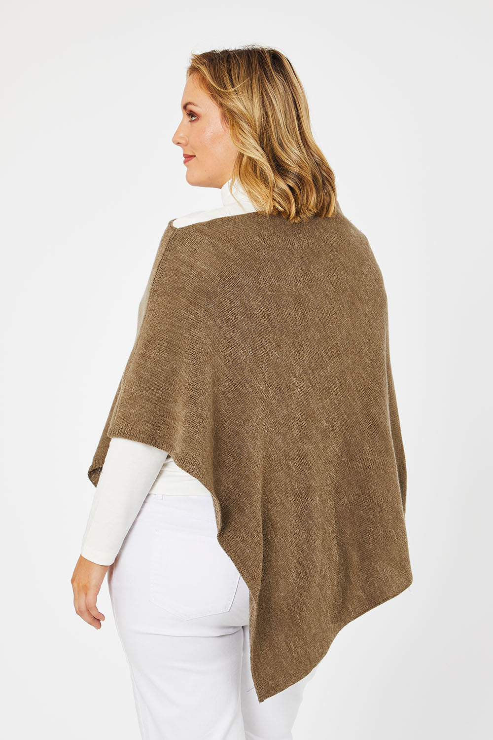 Model Jess wearing size L of The Perfect Poncho in colour Natural, from the back