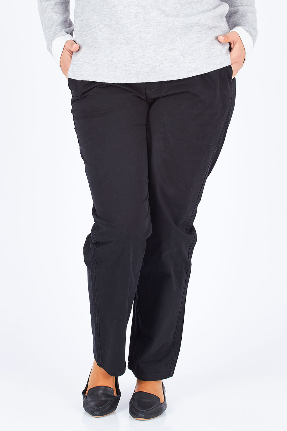 Model Natalia wearing size 14 of The Essential Chino in colour Black (Black), from the front, cropped image