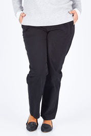 Model Natalia wearing size 14 of The Essential Chino in colour Black (Black), from the front, cropped image