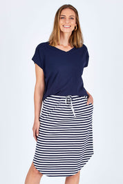 Model Riina wearing size 10 of The Weekender Comfort Skirt in colour Stripe (Black), from the front, cropped image
