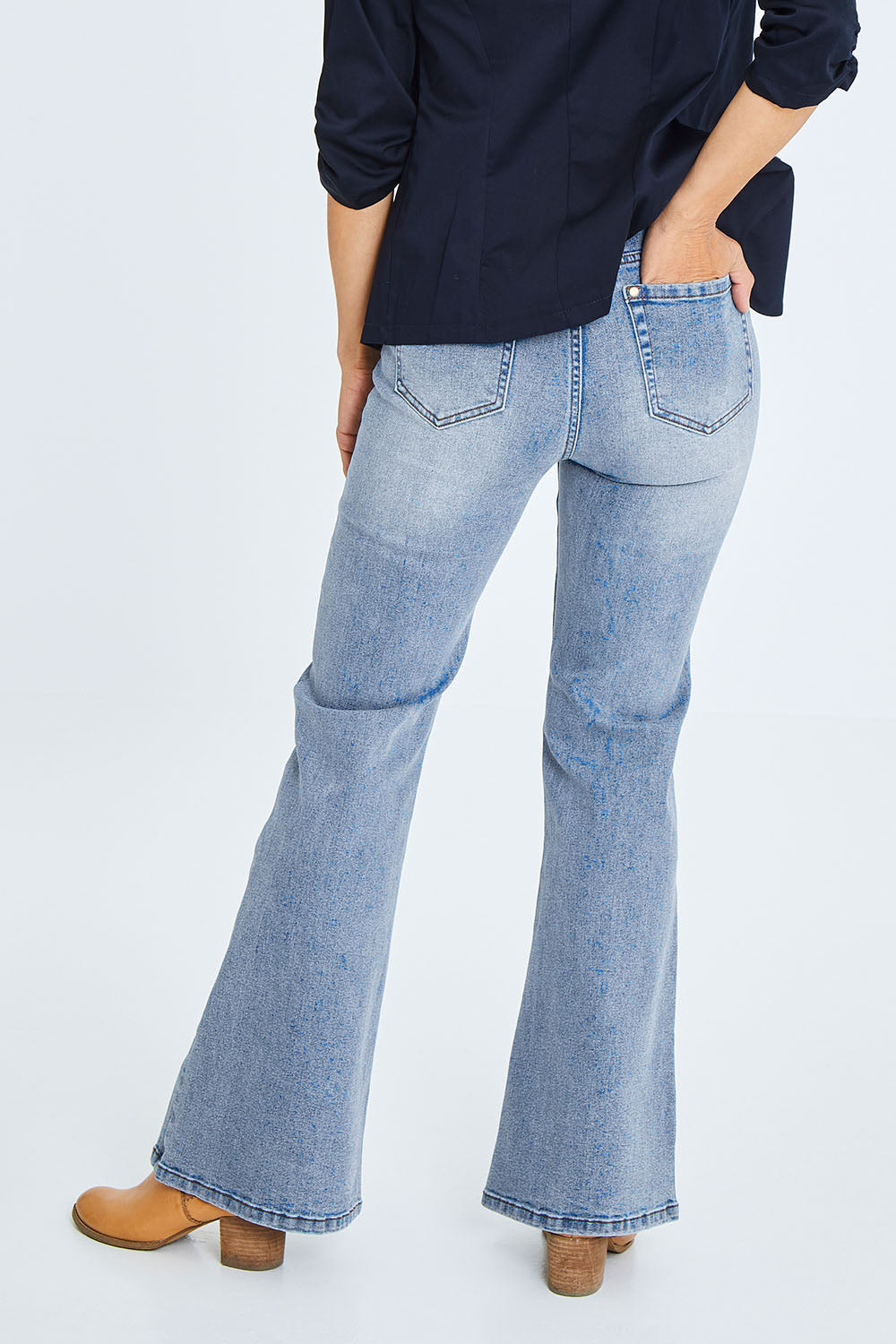 Model Cara wearing size 10 of The Bootcut Jean in colour Lightdenim (Blue), from the back