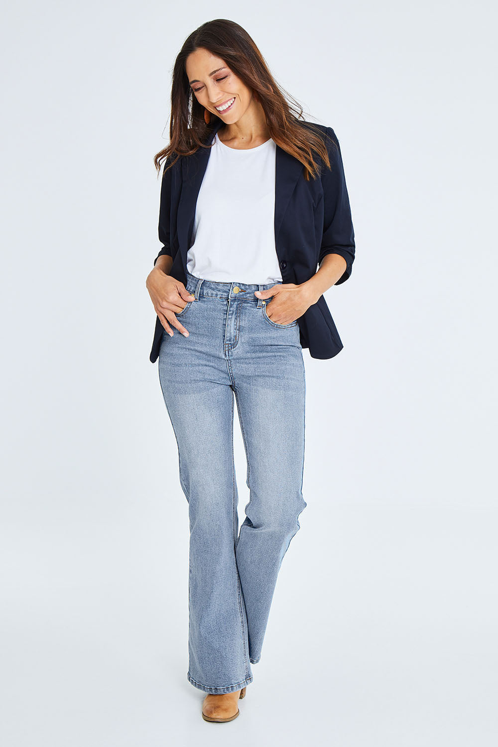Model Cara wearing size 10 of The Bootcut Jean in colour Lightdenim (Blue), from the front, showing the whole outfit