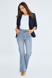 Model Cara wearing size 10 of The Bootcut Jean in colour Lightdenim (Blue), from the front, showing the whole outfit