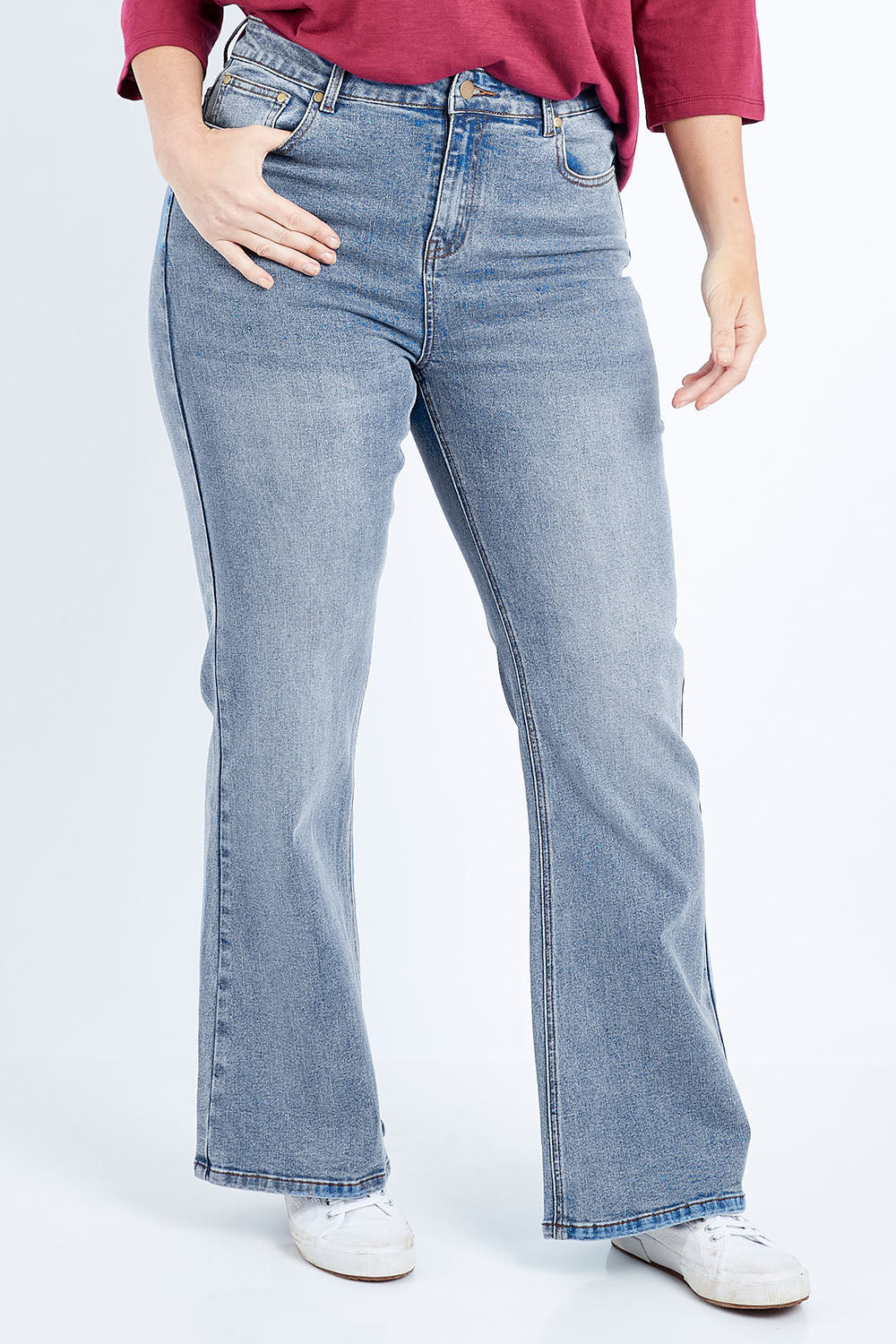 Model Laura wearing size 14 of The Bootcut Jean in colour Lightdenim (Blue), from the front, cropped image