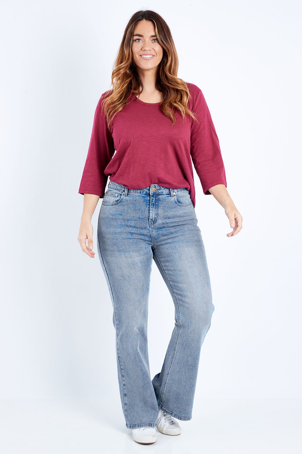 Model Laura wearing size 14 of The Bootcut Jean in colour Lightdenim (Blue), from the front, showing the whole outfit