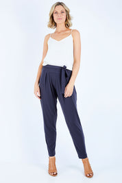 Model Chelsea wearing size 10 of The Comfort Pant in colour Charcoal (Grey), from the front, showing the whole outfit
