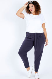 Model Jess wearing size 16 of The Comfort Pant in colour Charcoal (Grey), from the front, showing the whole outfit