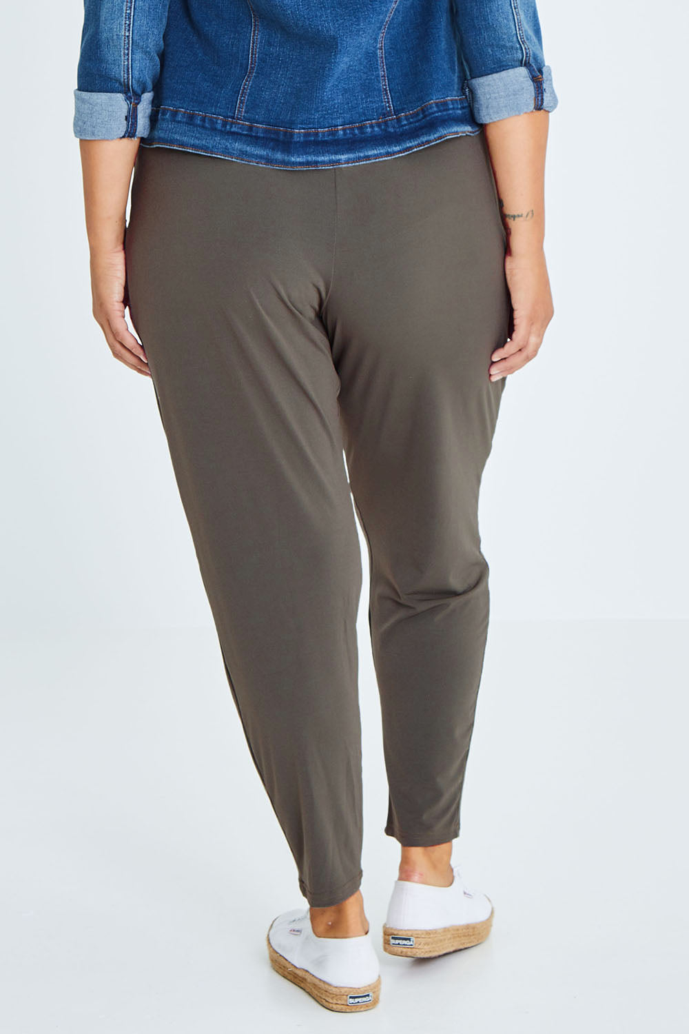 Model Palatina wearing size 16 of The Comfort Pant in colour Khaki (Green), from the back
