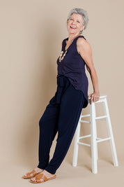 Model Elise wearing size 10 of The Comfort Pant in colour Navy (Blue), from the front, showing the whole outfit
